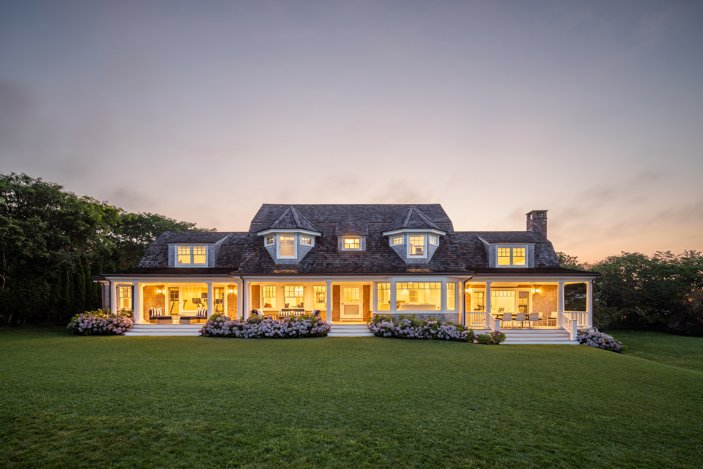 The expanded Shingle Style residence on Starbuck Neck in Edgartown at dusk