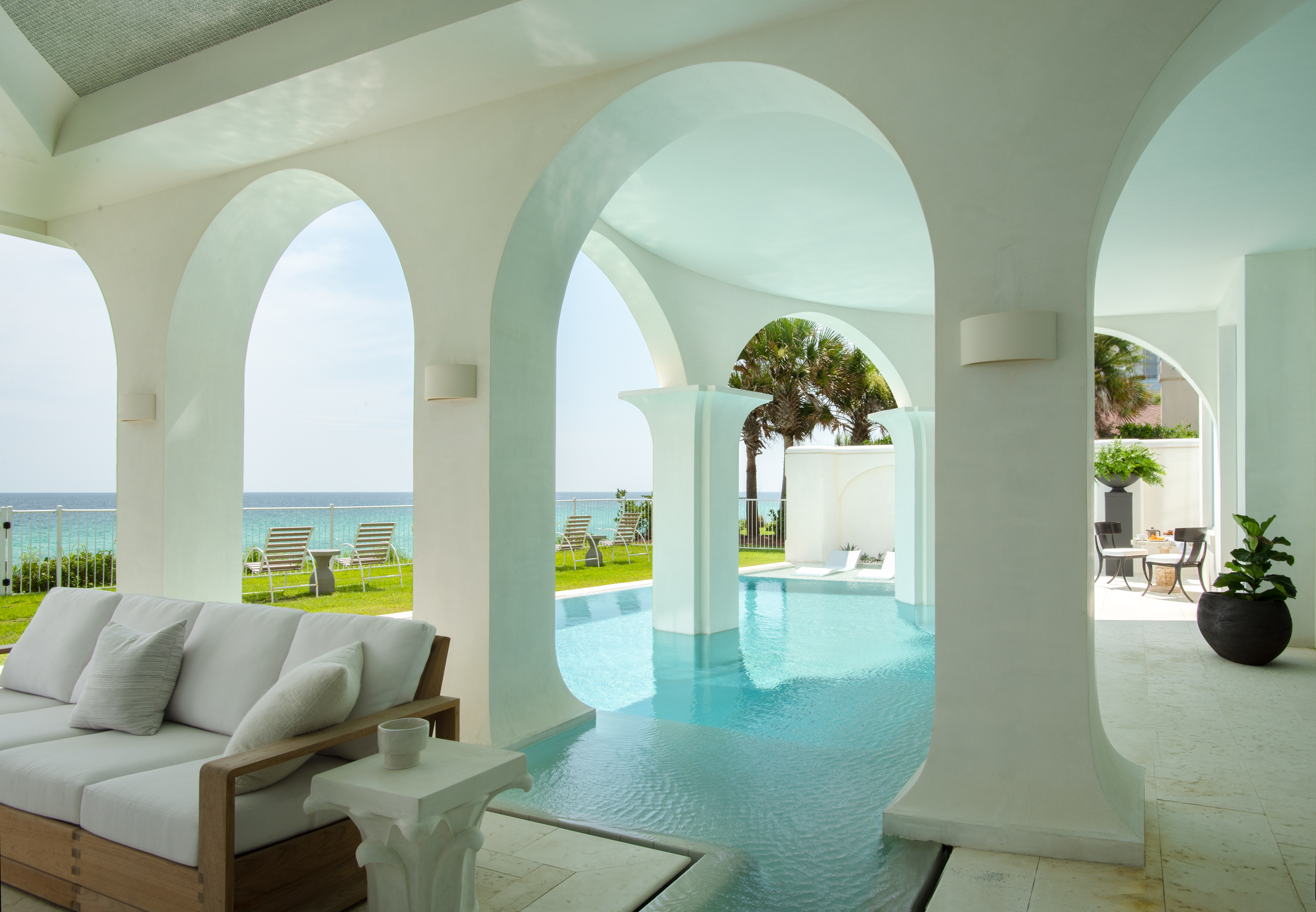 Columns rise from an Aegean-blue pool at a Gulf-front home on Florida's Emerald Coast