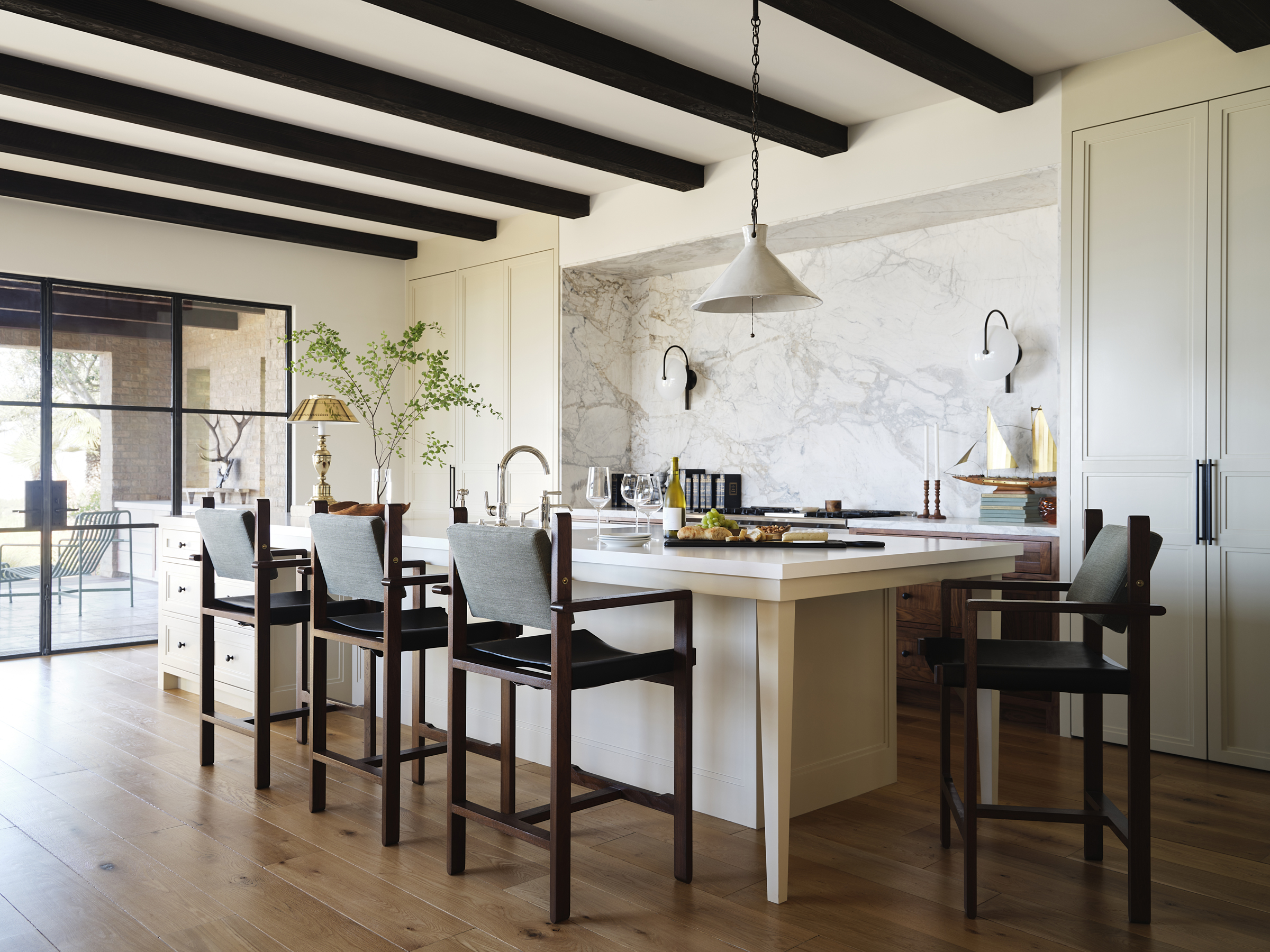 A serene Newport Beach kitchen by Tim Barber Architects with concealed cabinetry and ocean views