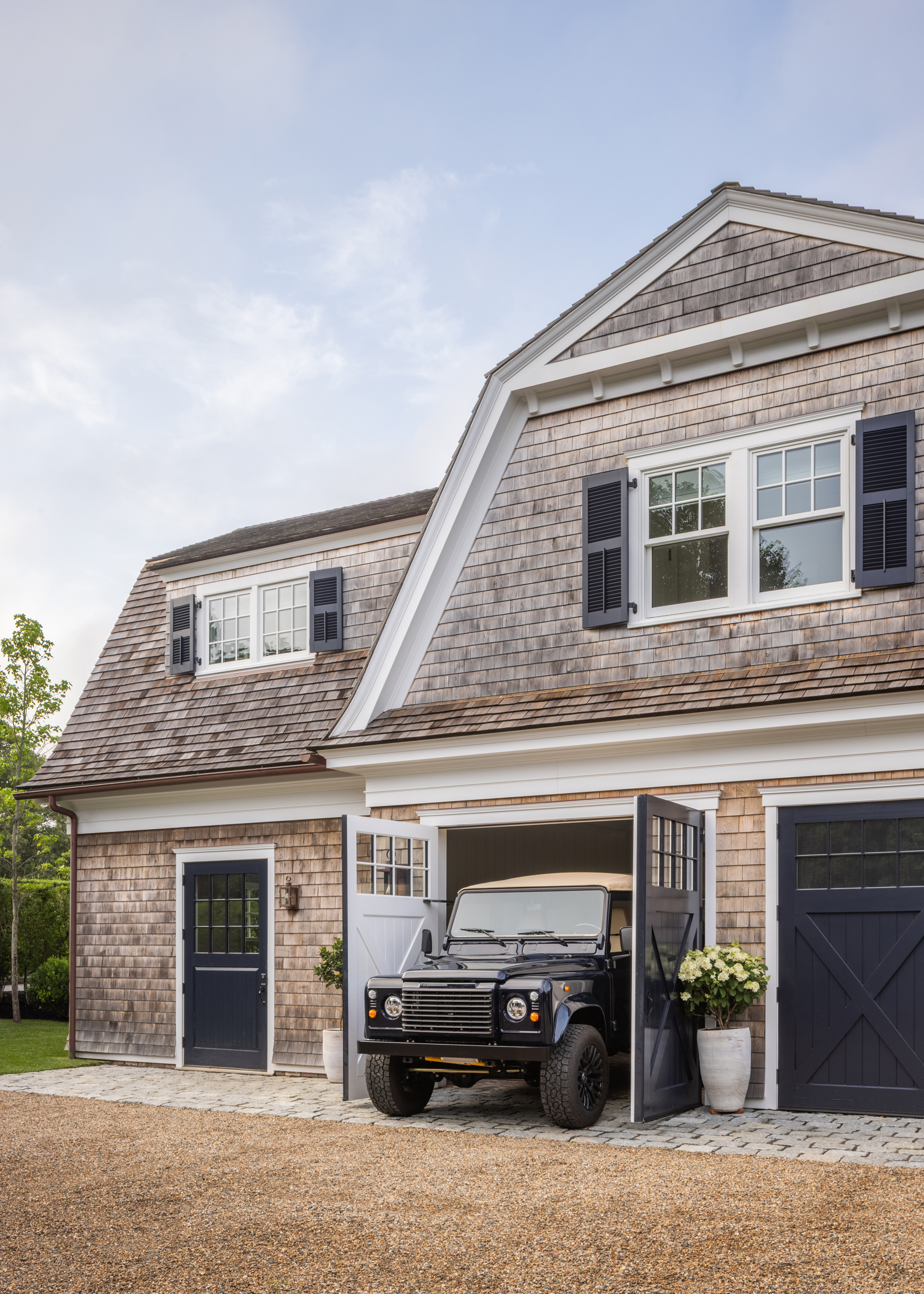 The shingled carriage house and garage designed to echo the historic main residence