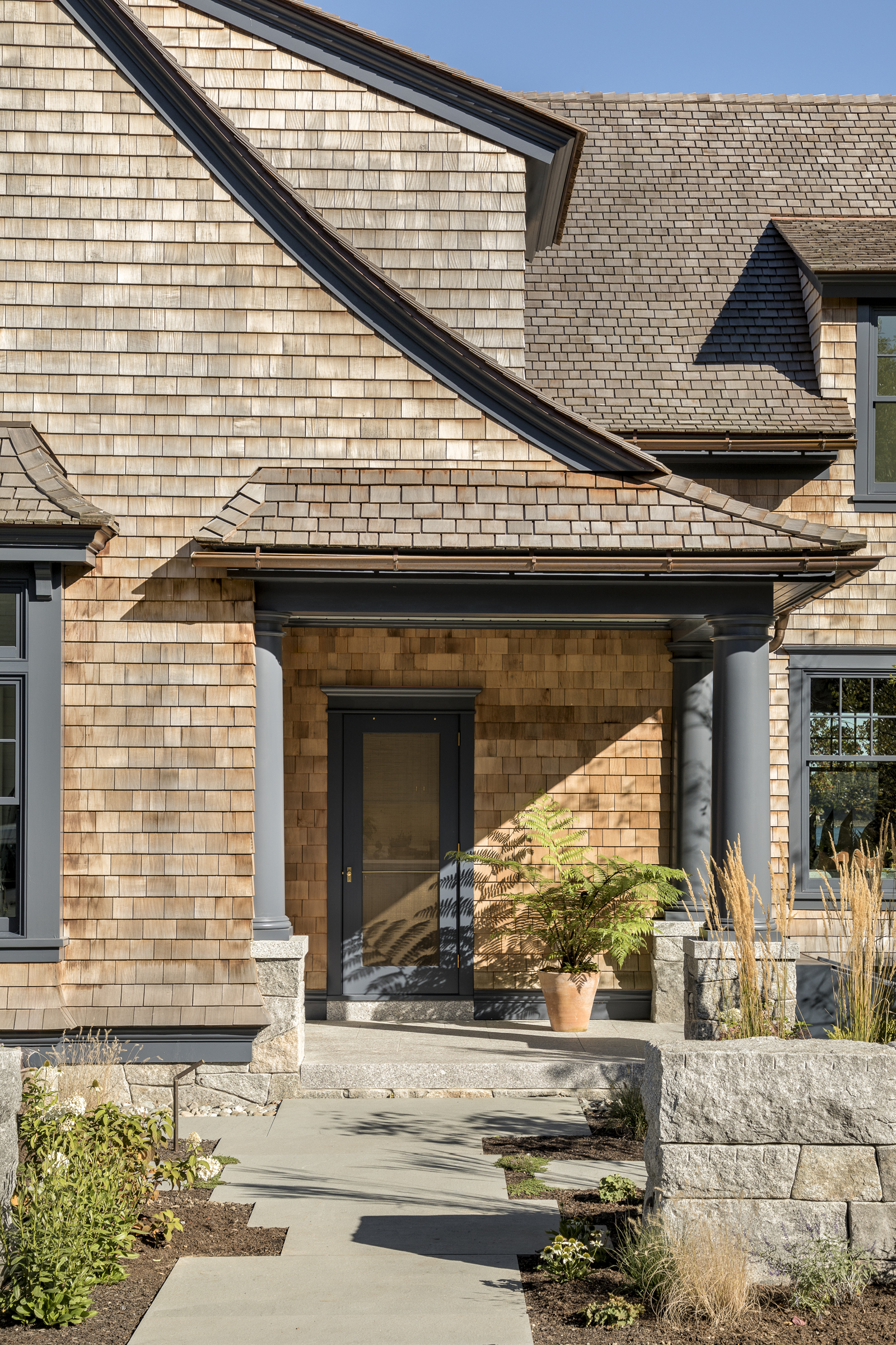 Granite steps lead to the columned family entry porch