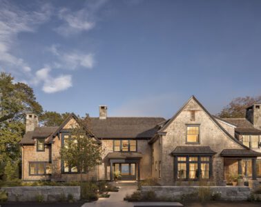 A cedar-shingled Peter Zimmerman residence set low among trees on the coast of Maine