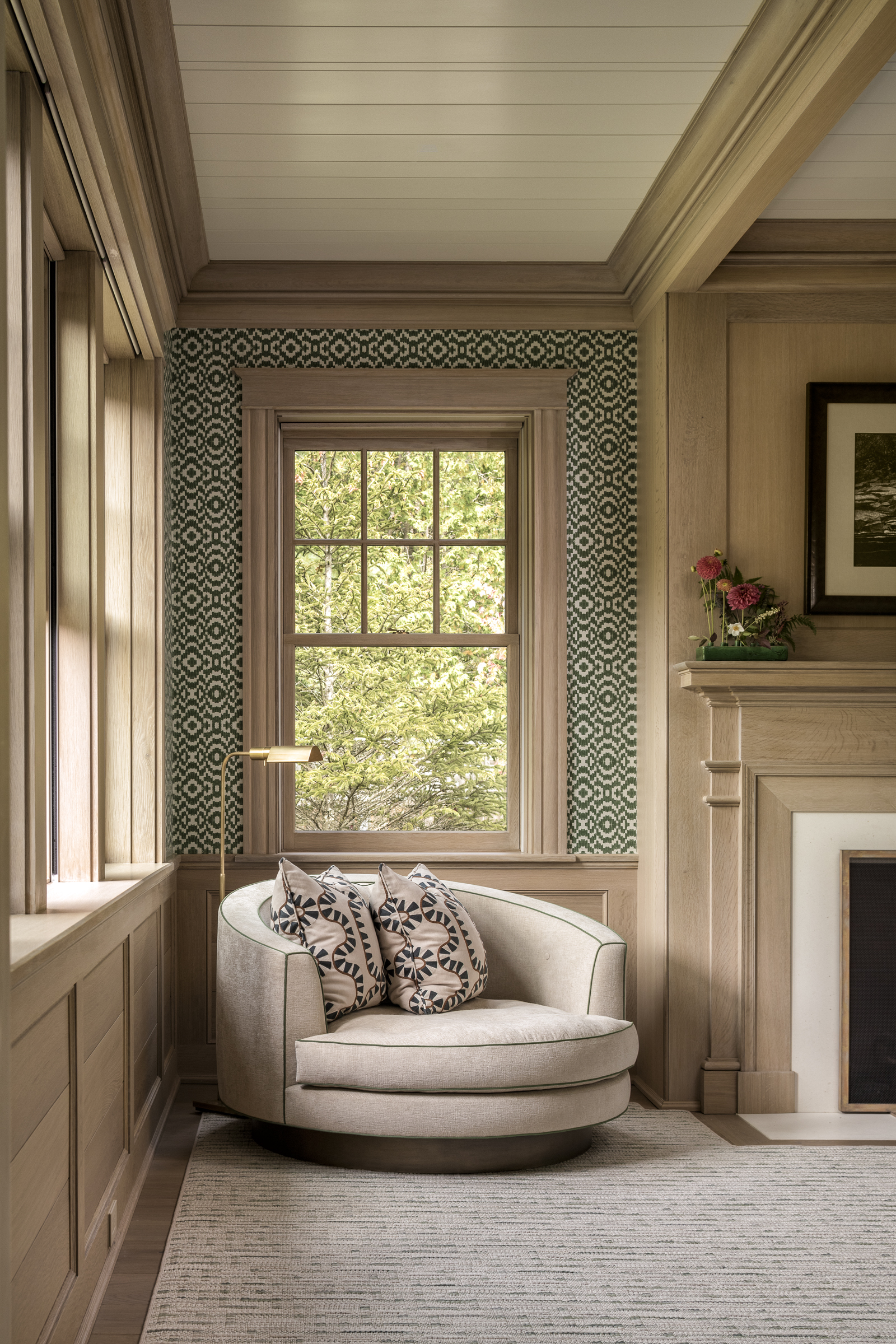 A patterned niche off the study holds a swivel chair and reading lamp
