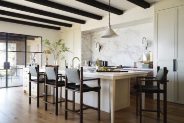 A serene Newport Beach kitchen with concealed cabinetry and a marble niche