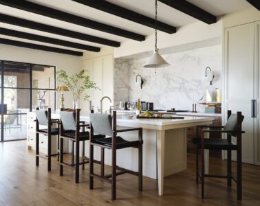A serene Newport Beach kitchen with concealed cabinetry and a marble niche
