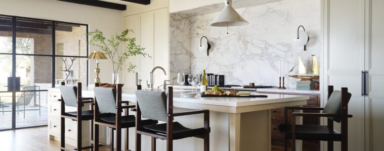 A serene Newport Beach kitchen with concealed cabinetry and a marble niche
