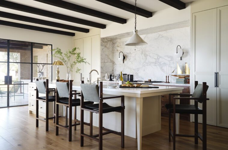 A serene Newport Beach kitchen with concealed cabinetry and a marble niche