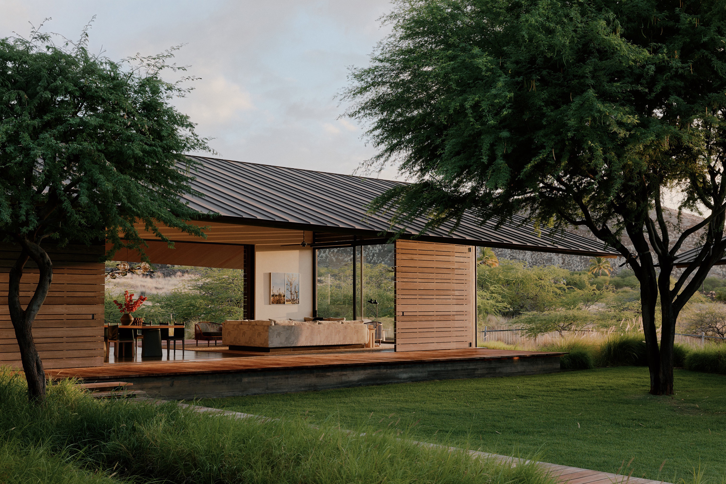 Movable wood doors open a low living pavilion to the central lawn