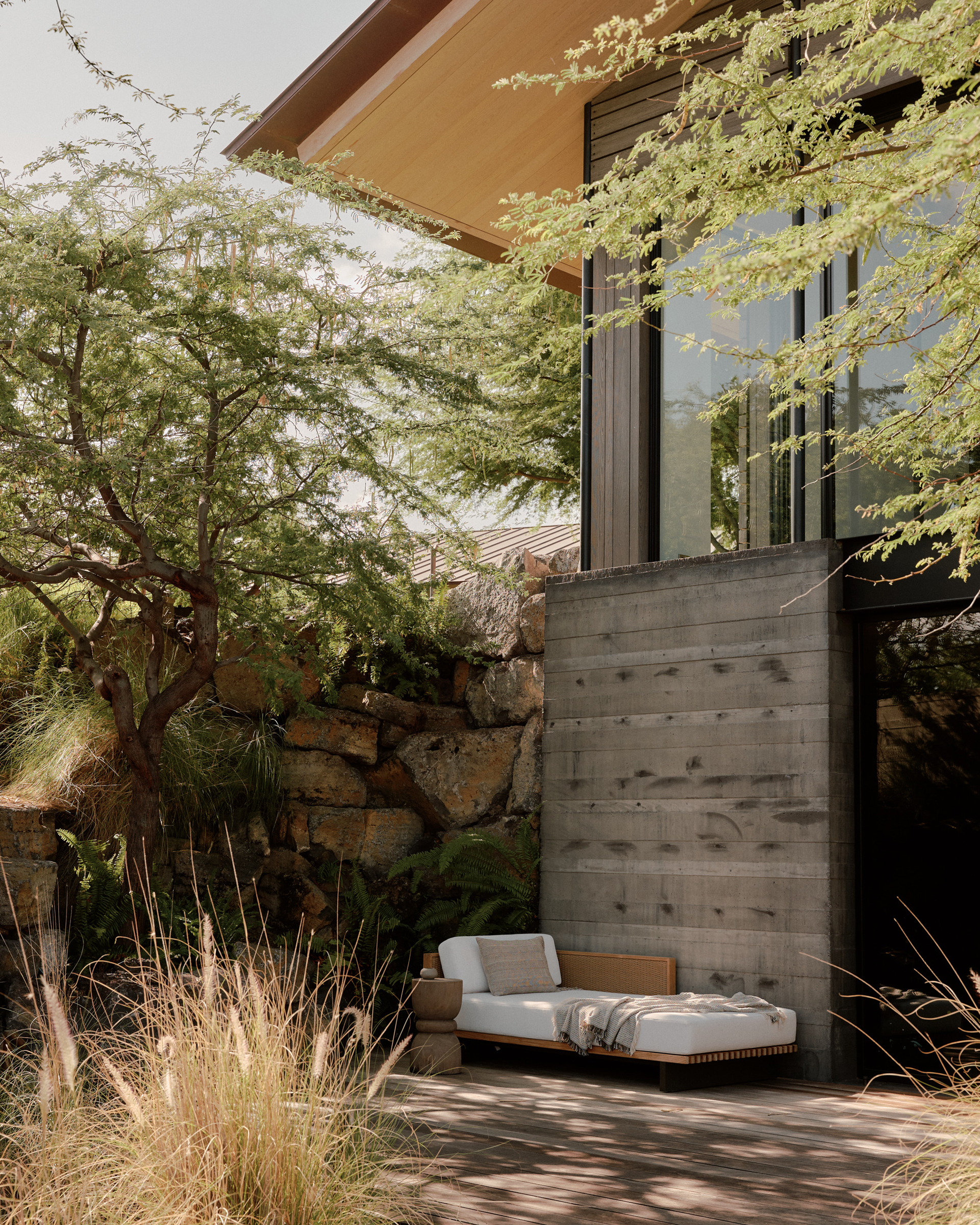 A partially submerged yoga studio nestles into the Kona lava field