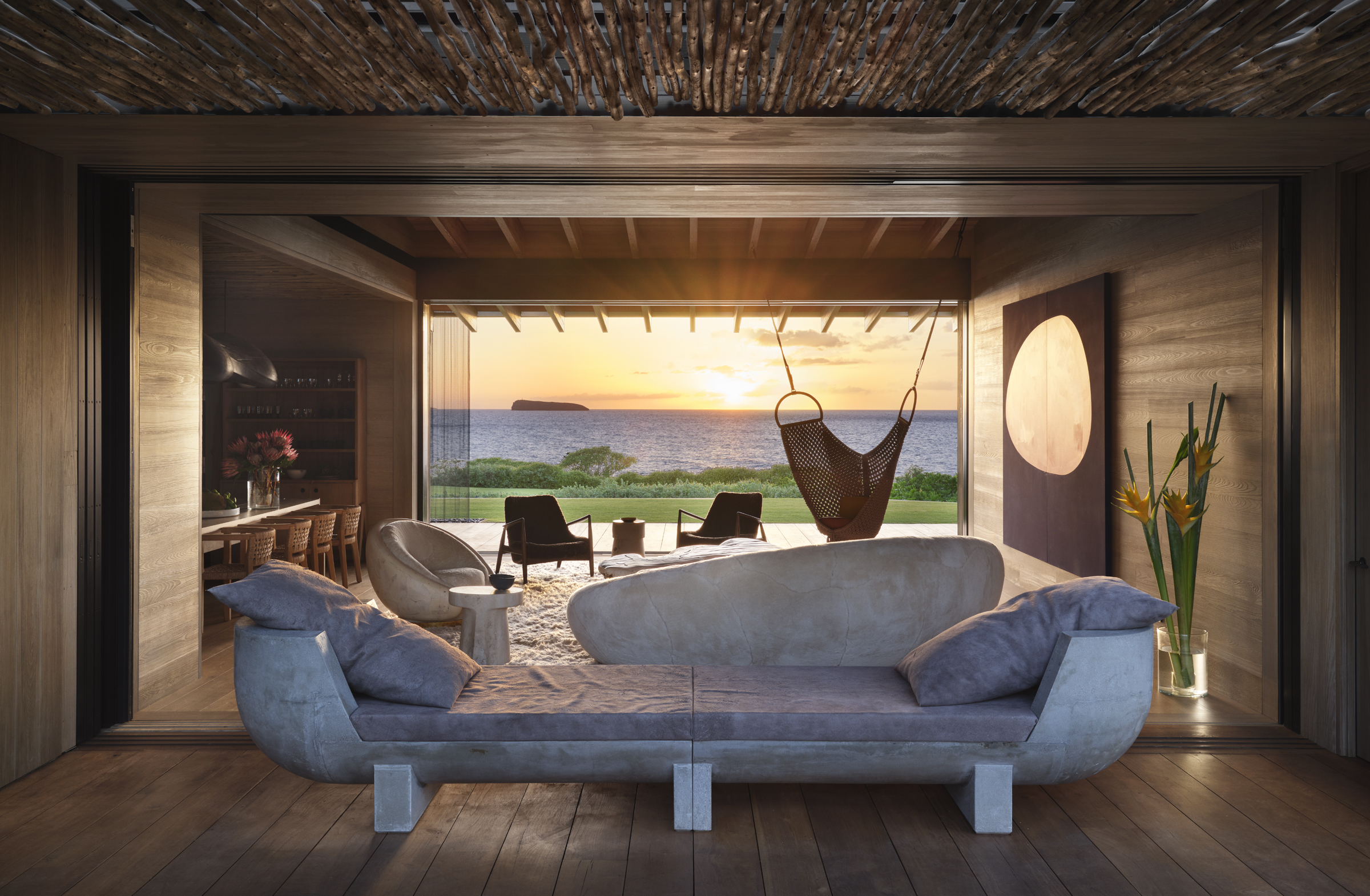 The great room opens fully to the Pacific at sunset