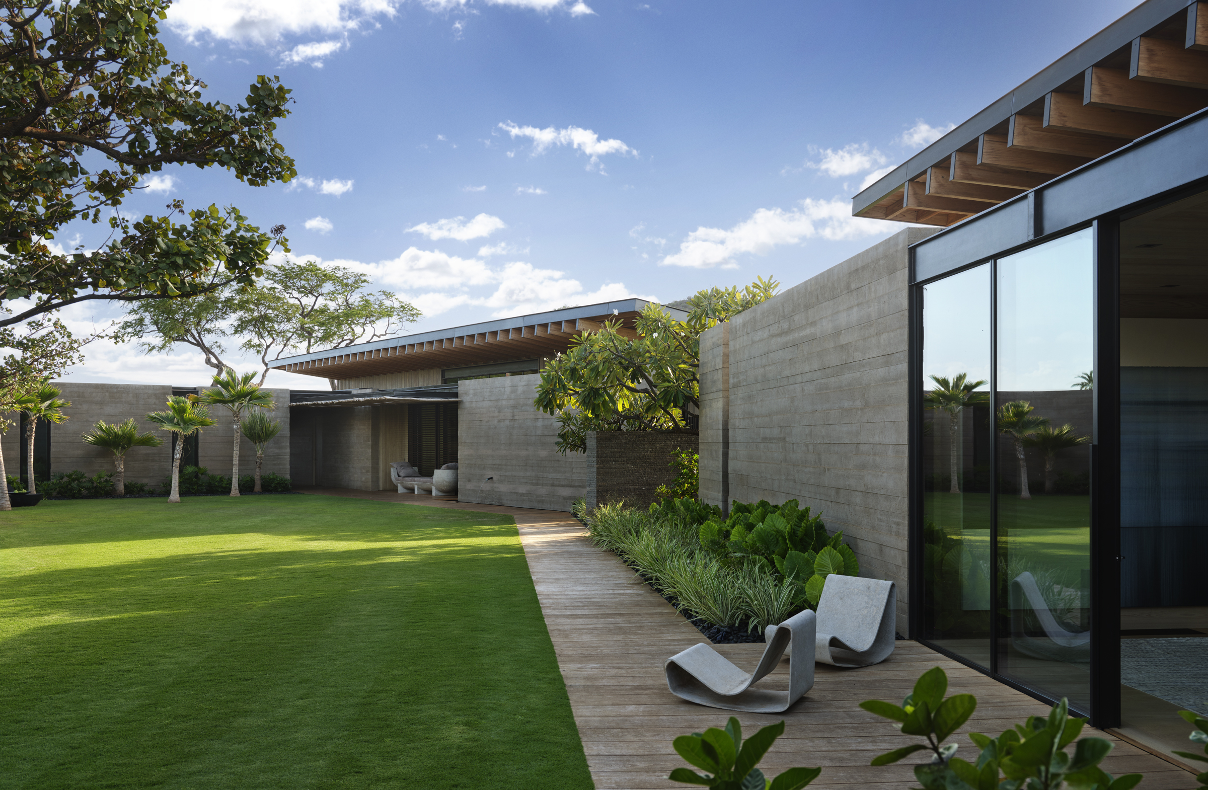 A boardwalk threads between low pavilions and salt-tolerant planting