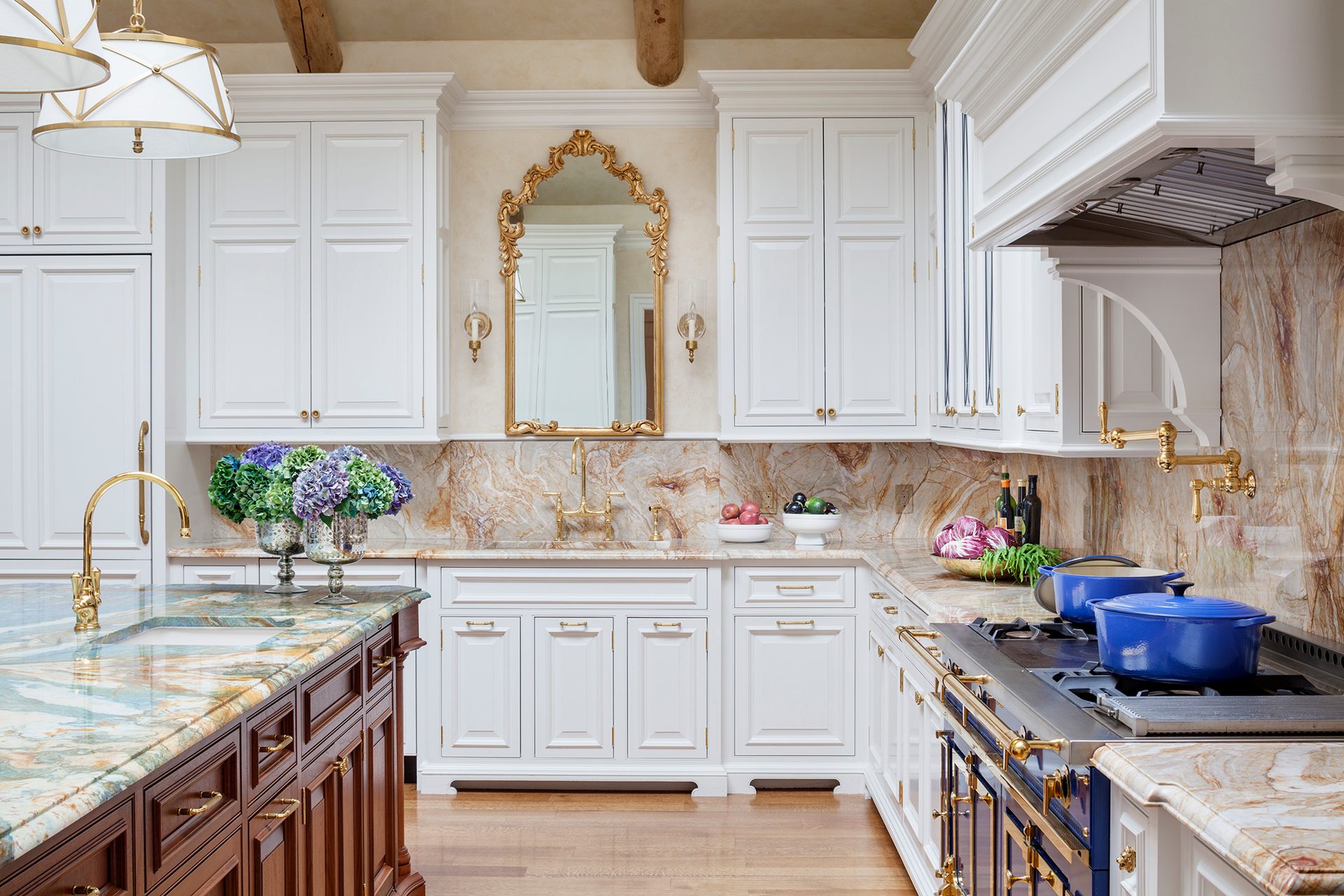 Laurel Woods main kitchen with white cabinetry, a marble backsplash, and a large range hood