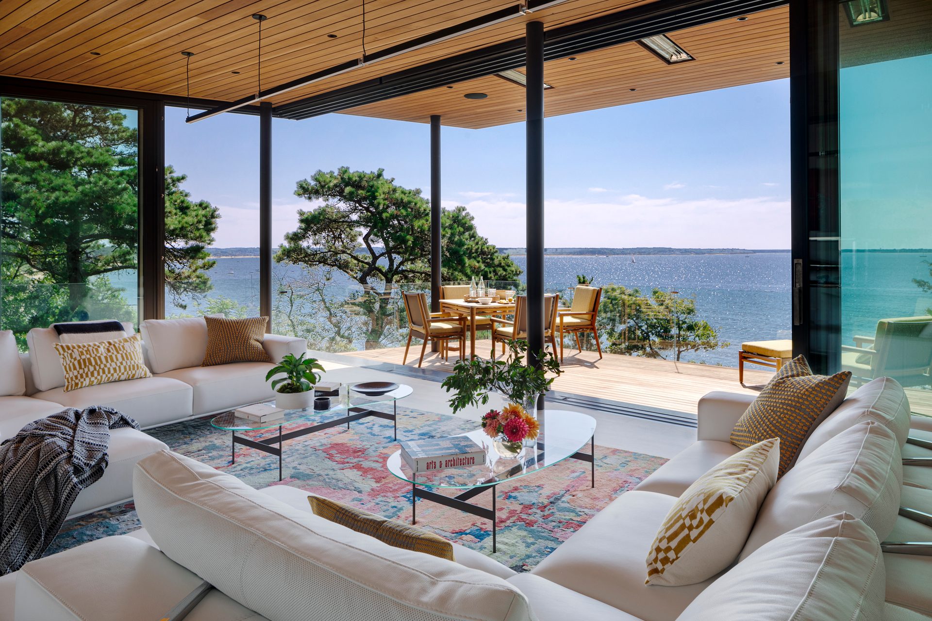 Miter Point living room opening onto a covered deck and views of Wellfleet Harbor