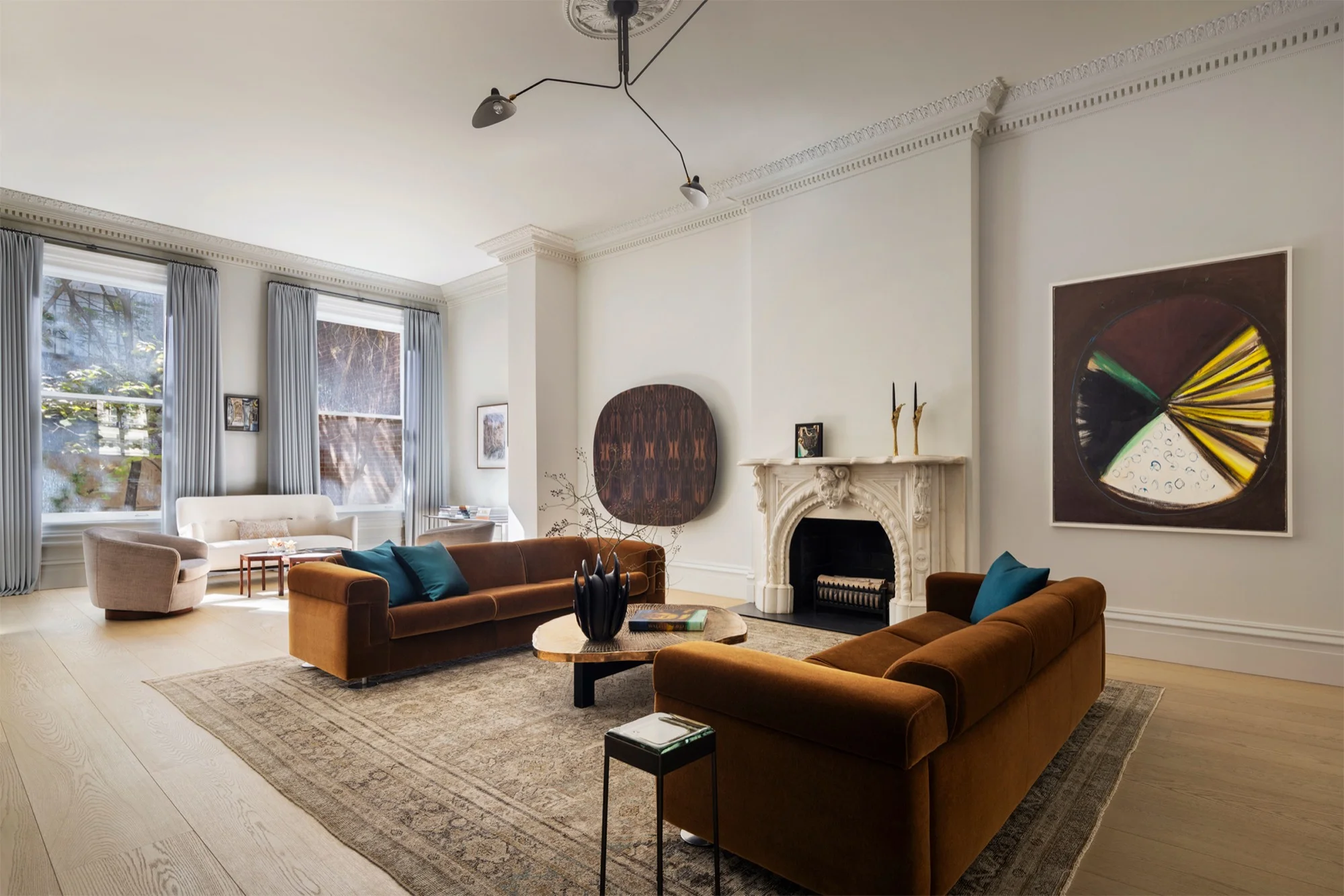 Residential living room by TenBerke with tall windows and contemporary seating